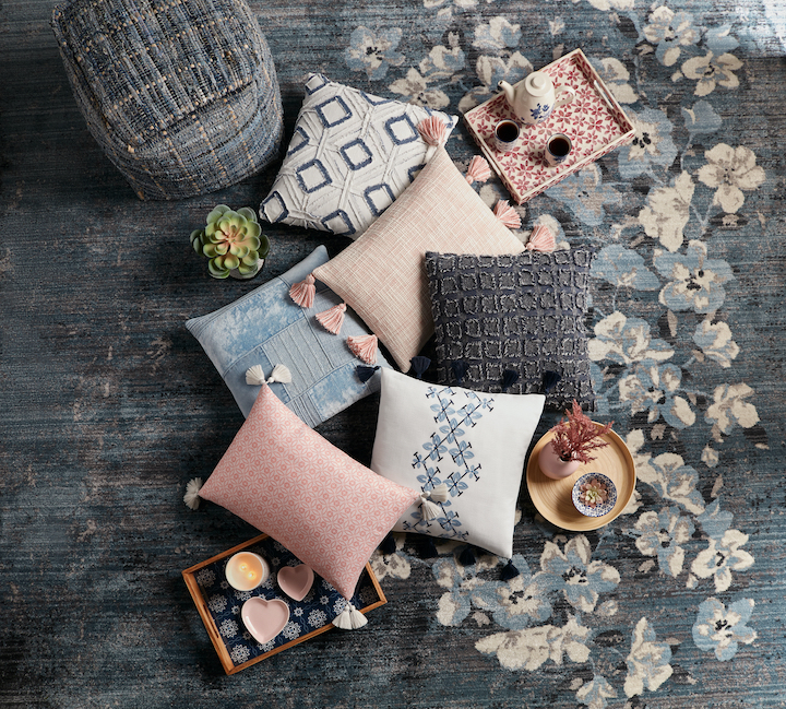 image of assorted pillows and decor on blue floral design rug