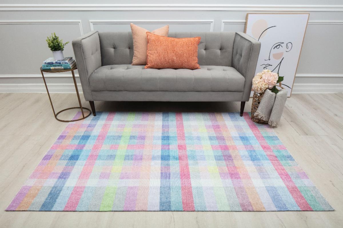Modern plaid style area rug in pinks, reds, yellows and blues