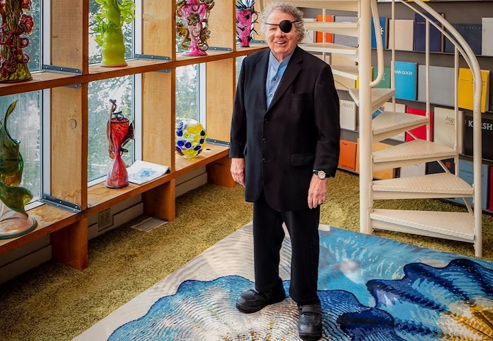 portrait of artist in his glass studio and with new rug