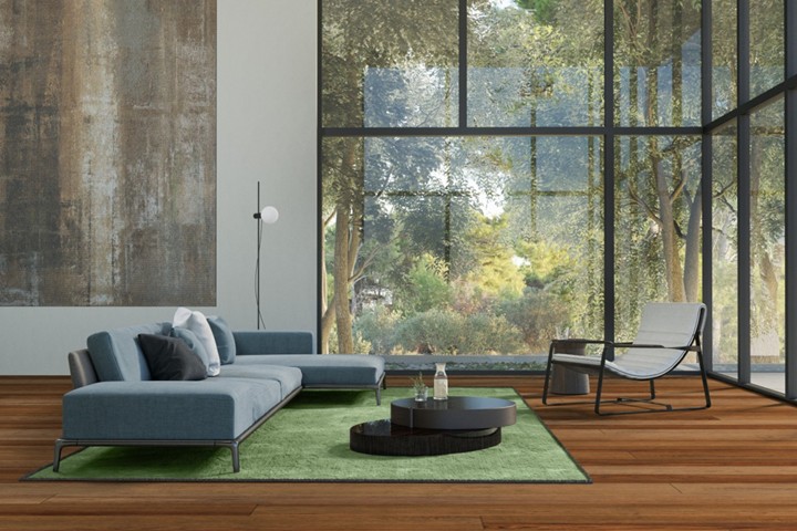 Image of contemporary living room with green rug and hanging abstract design in earth tones
