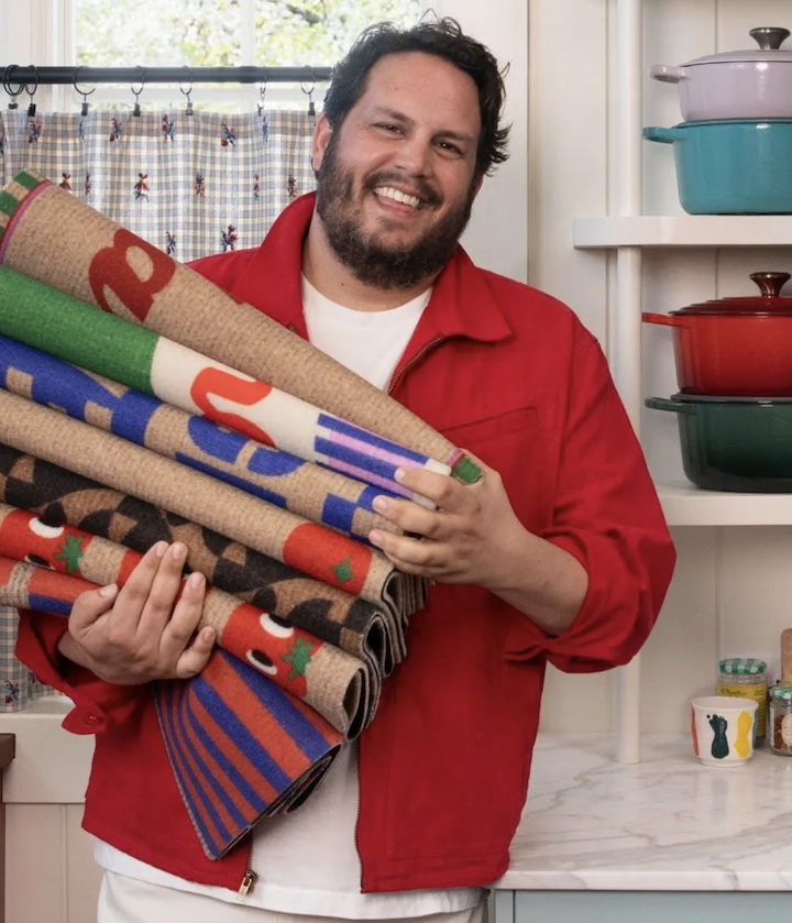 Portrait of Dan Pelosi holding some of his Ruggable rugs