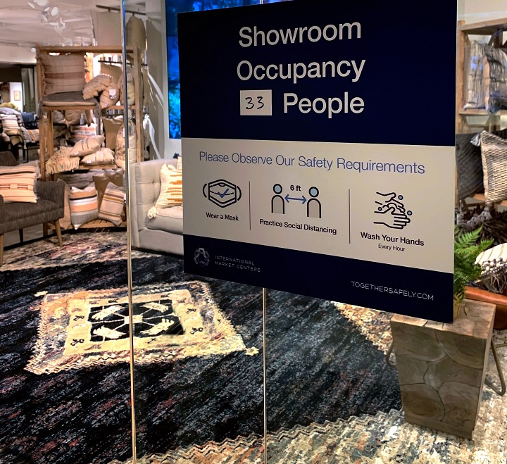 A sign showing showroom occupancy as well as safety protocols