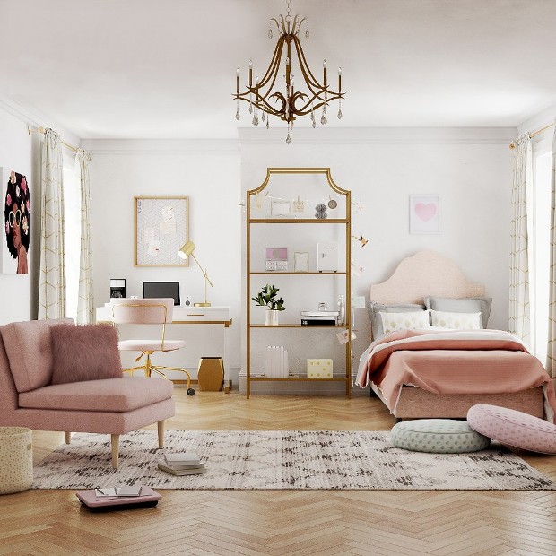 A bedroom with pink velvet and gold accents