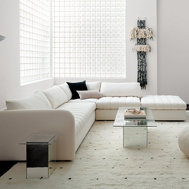 A cream and black living rom with mirrored accent tables