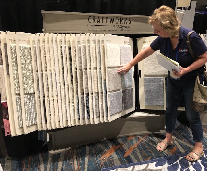 image of buyer reviewing Nourison's craftwork samples display