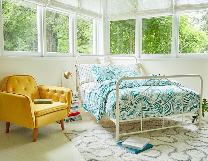 bedroom with bright contemporary textiles and area rug