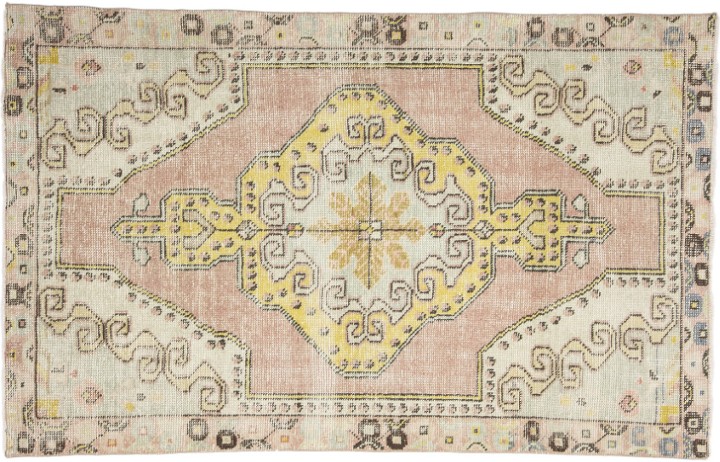 A biege rug with yellow, gold and pink accents