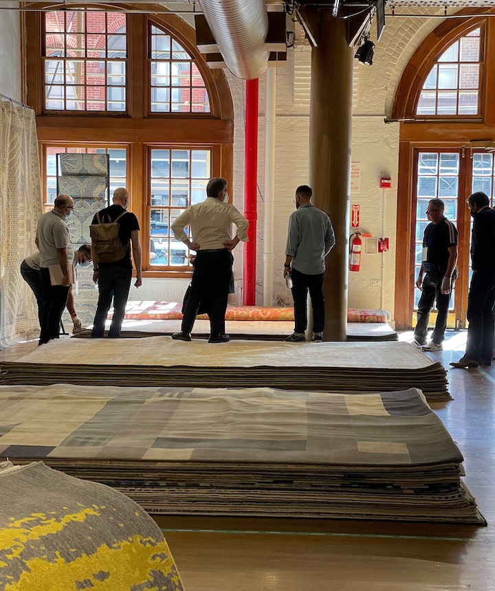 phot of rug buyers reviewing area rugs at cover connect