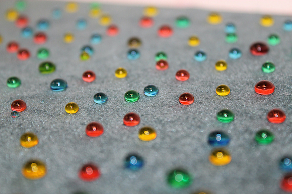 image of colored beads of water on carpet