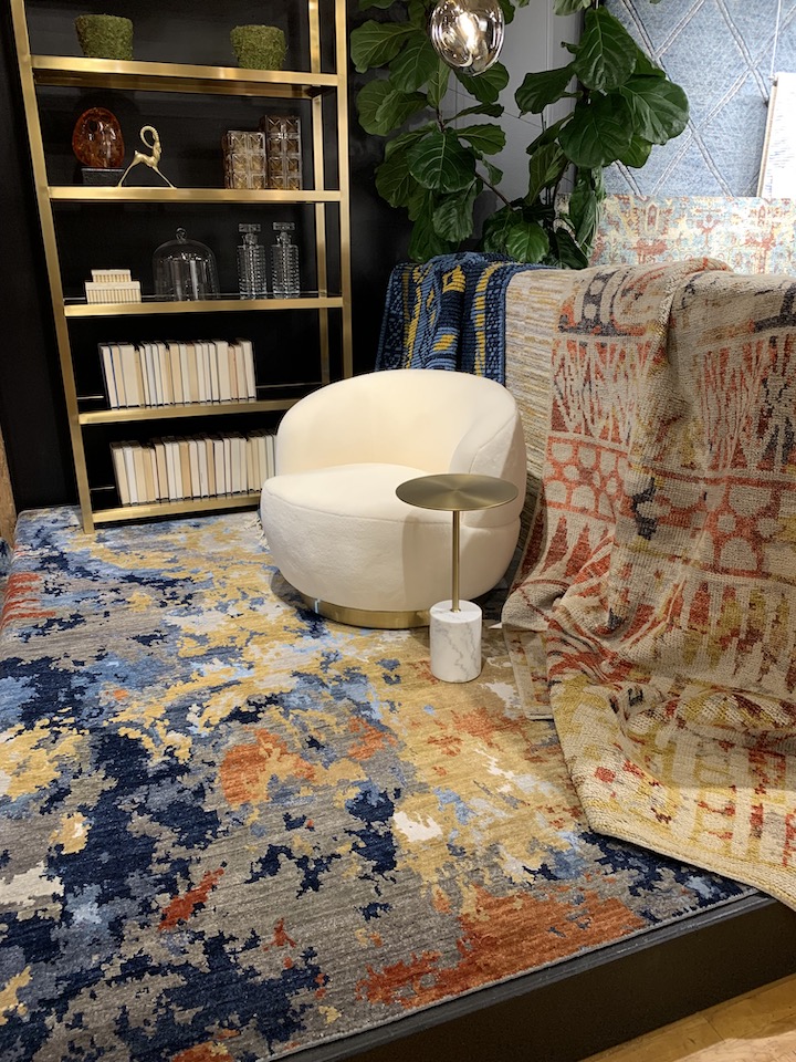 showroom display featuring abstract rug and tribal design with round armchair