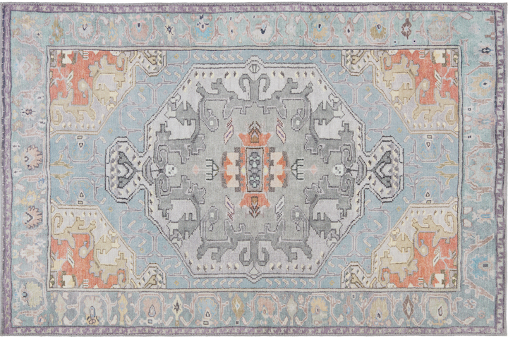 a classic medallion design area rug in modern blue gray and orange palette