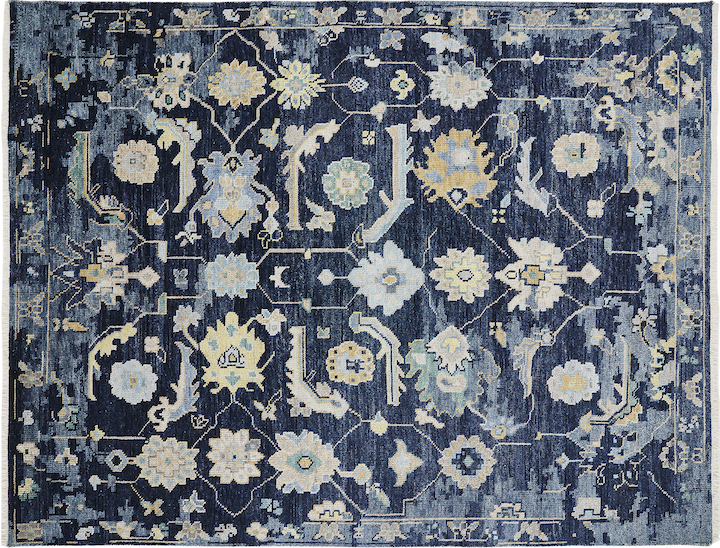 floral and vine motif rug with distressed look in blue