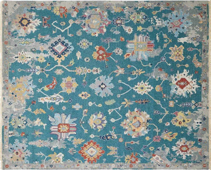 a hand-knotted oushak style rug with erased effect and turquoise blue background.