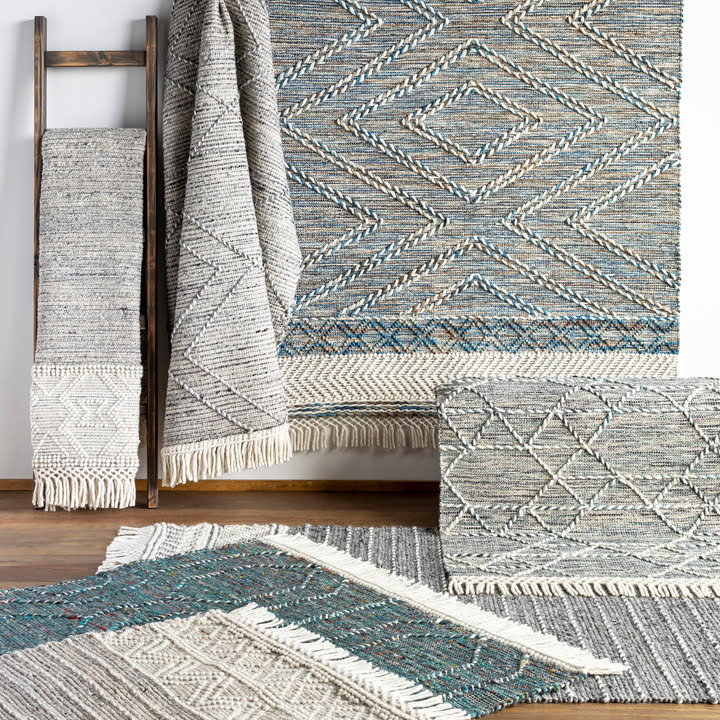 A display of chunky braided geometric rugs