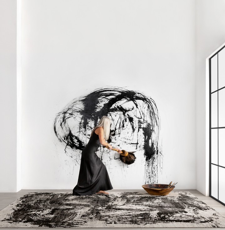 a black and white abstract rug and artist painting wall