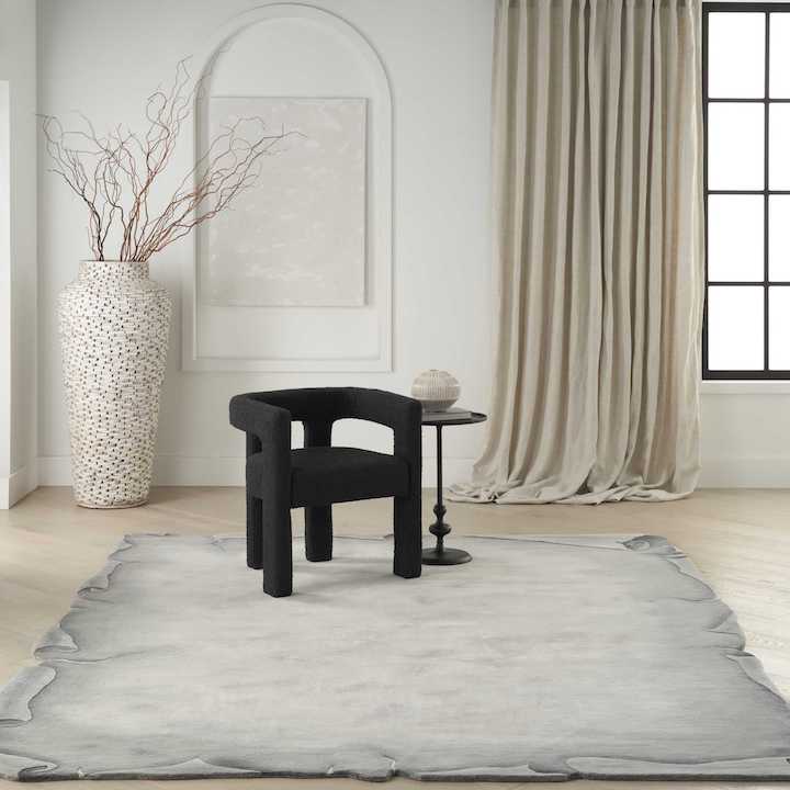 a gray rug with a design like antique scrolls by Nourison