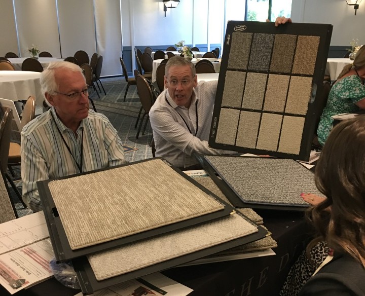 image of FCA rug buyers reviewing broadloom samples