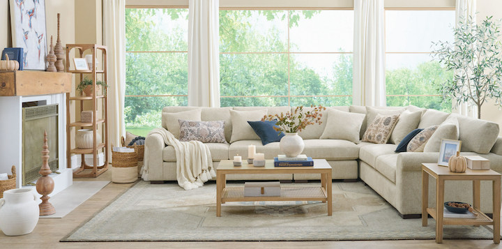 A living room in easy neutrals and natural textures, featuring a cream hued medallion rug
