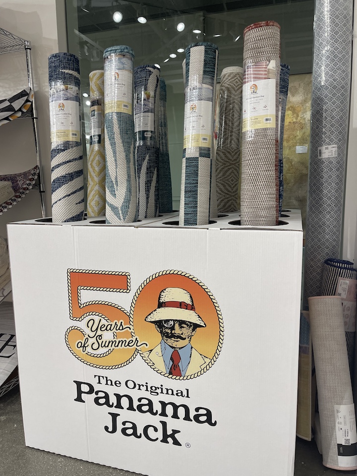 Box display with rolled up Panama Jack outdoor rugs by Unique Loom
