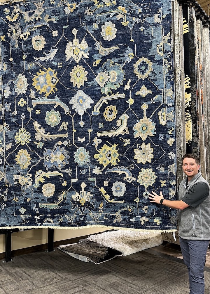 Spencer Wien of Marshall Flooring shows off Kalaty's hand-knotted Ambrose rug