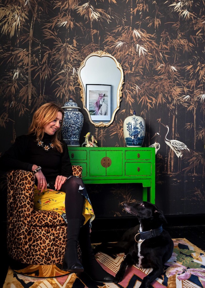 Designer Wendy Morrison and her dog Eddie in a chinoiserie style setting with her rugs and wallpaper
