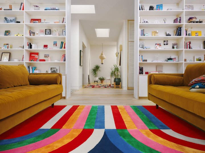 living room scene featuring rainbow-inspired colorful area rug by Laura Niubo